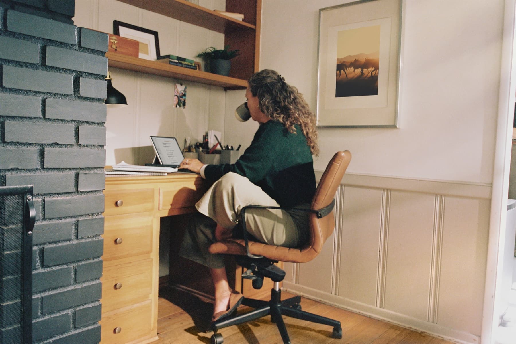 Woman working on a laptop in a home office