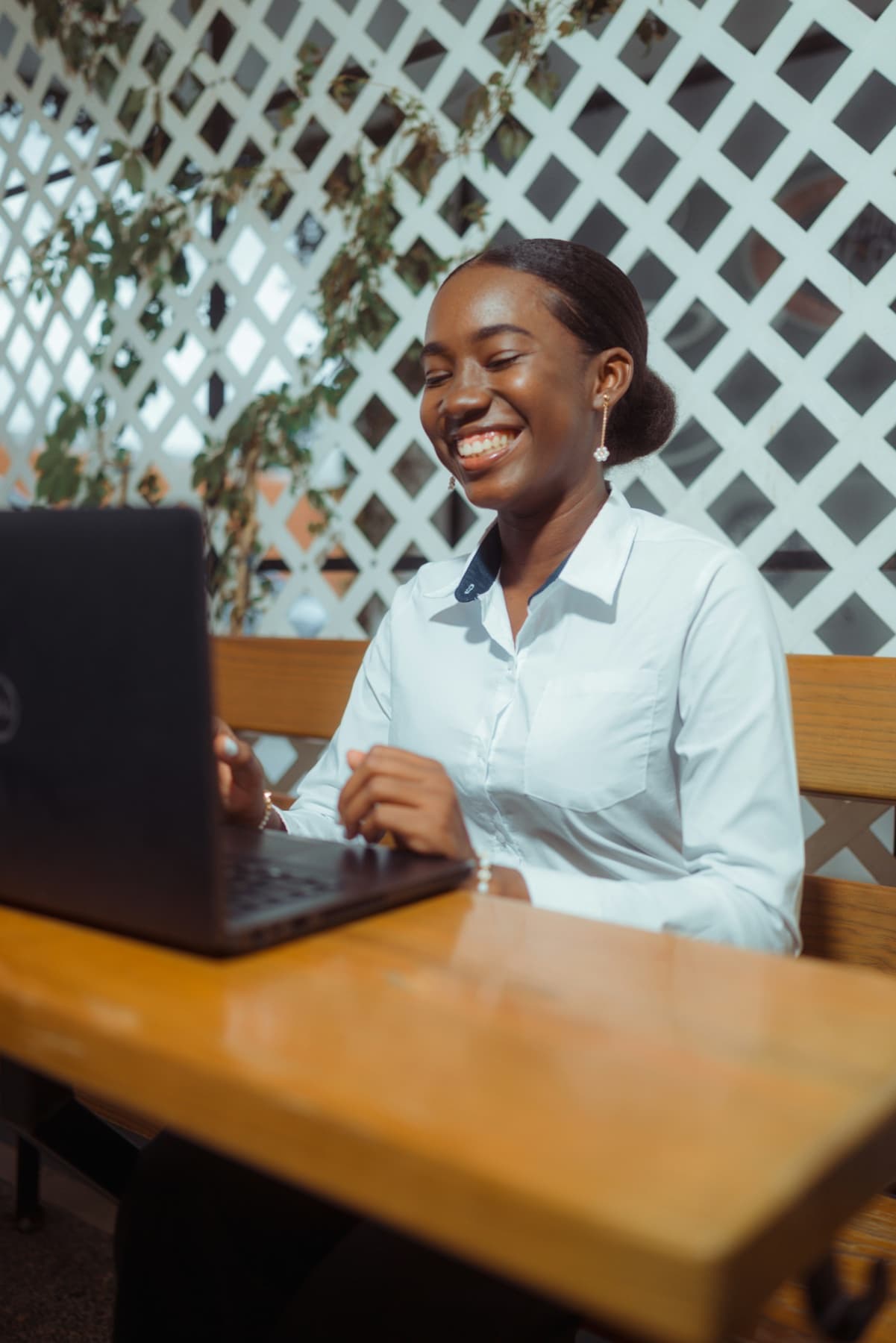 Woman smiling while working on a laptop
